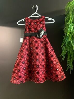 Red Patterned Holiday Dress with silver sequence and Black Sash.